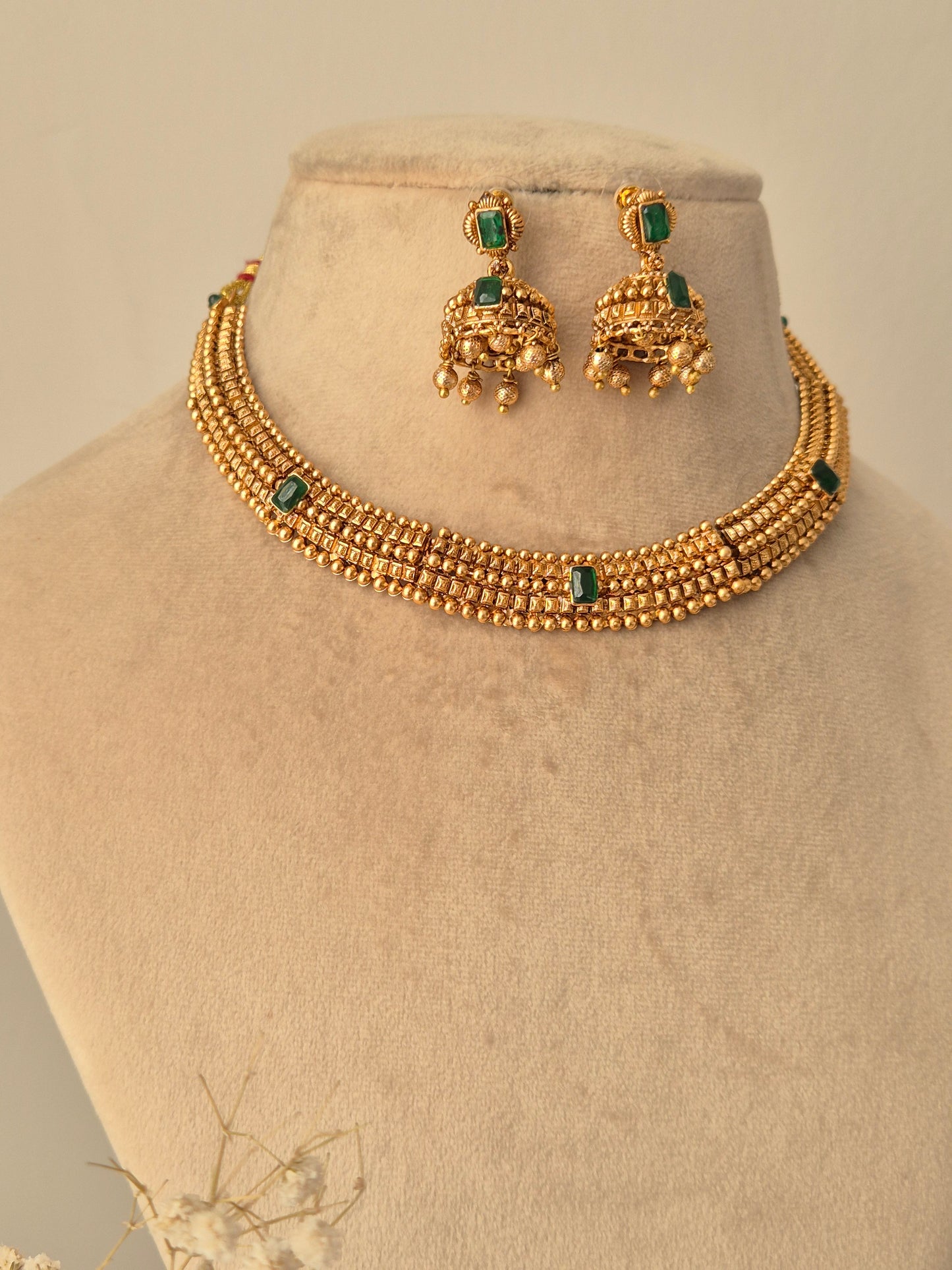 Traditional elegant necklace set with green stones with matching design Jhumki available at naitri.in