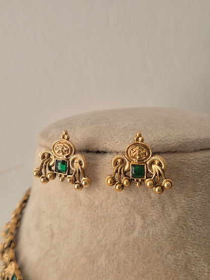 A pair of gold-toned earrings with square green gemstones, by naitri.in