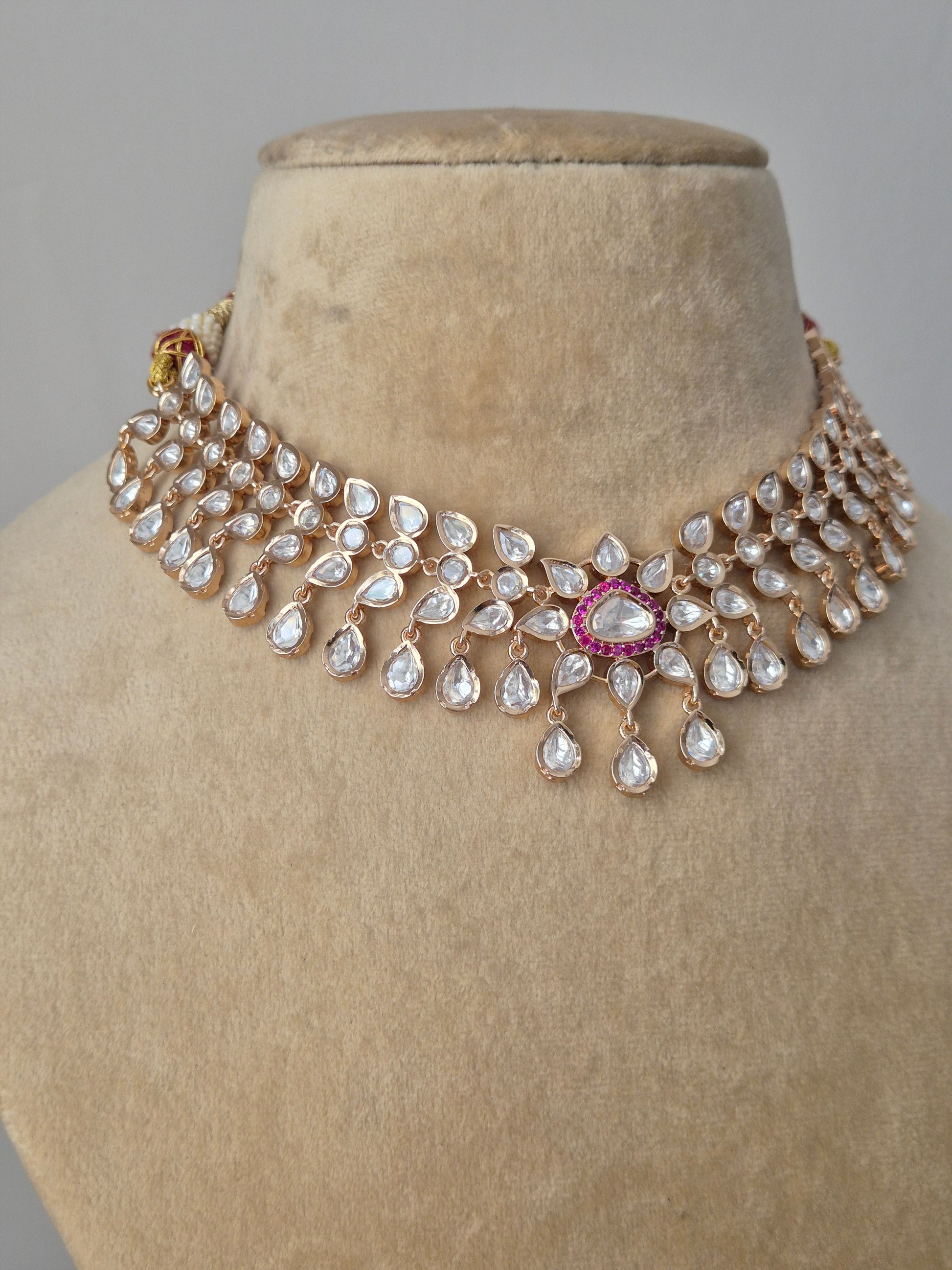 "Exquisite Rosalie necklace set featuring a refined finish of American Diamonds and vibrant red stones, perfect for weddings and festive sarees by naitri.in