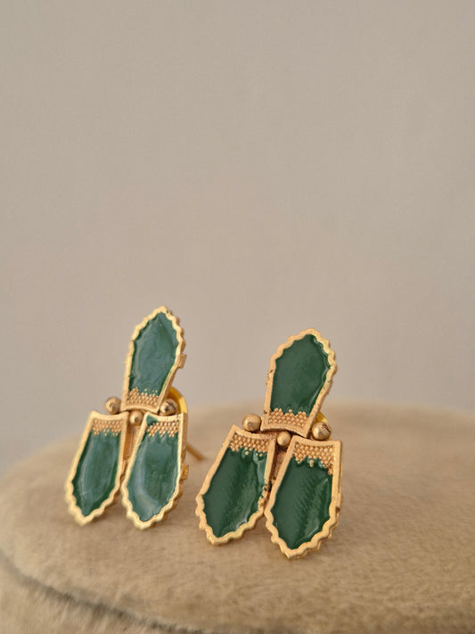 A pair of gold-tone earrings with green enamel inlay, by naitri.in