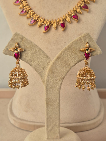 Traditional gold jhumka earrings with floral designed dangling gold beades by naitri.in