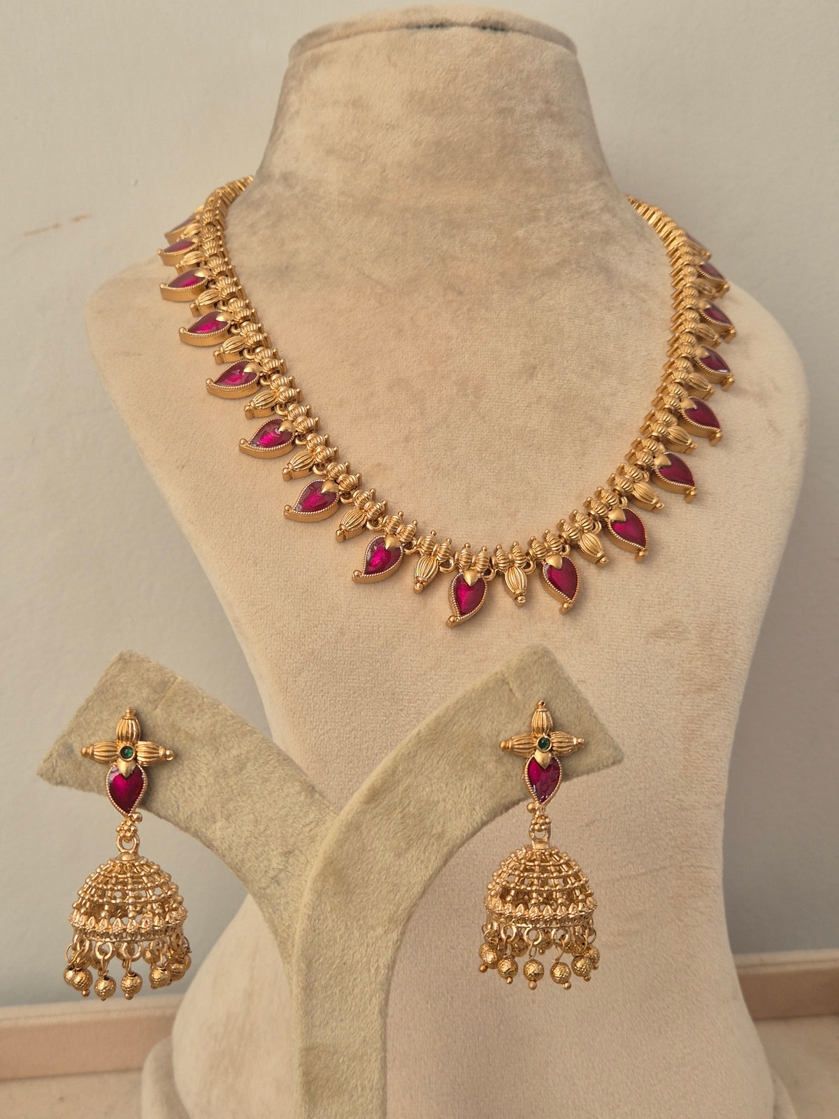 Famitha Gold Necklace Set with Ruby Stones and Jhumka Earrings | Naitri Ethnic Jewellery and Traditional gold necklace and jhumka earring set with ruby red stone detailing by naitri.in