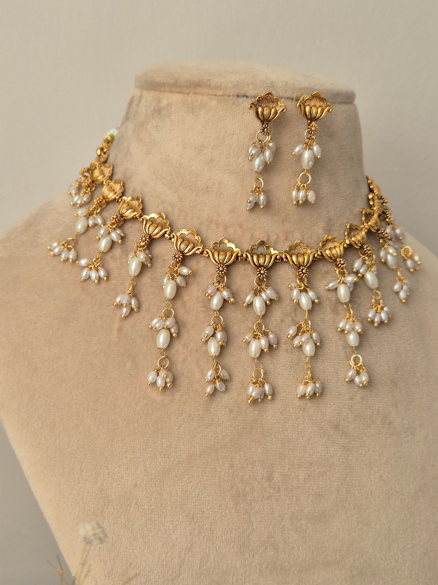 Gold and long shaped pearl jewelry perfect for wedding and festival light weight and easy to carry by naitri.in