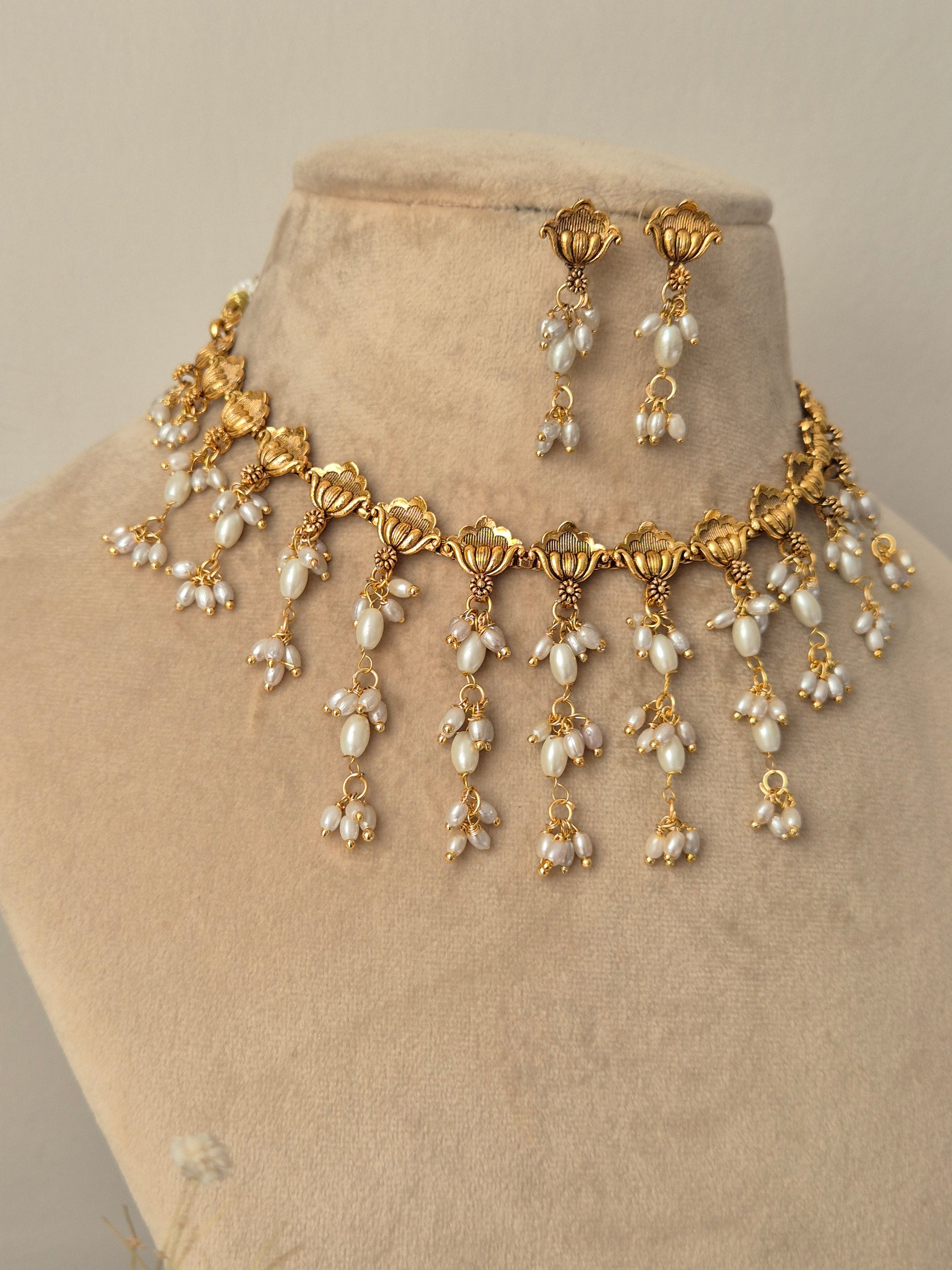 Gold and long shaped pearl jewelry perfect for wedding and festival light weight and easy to carry by naitri.in