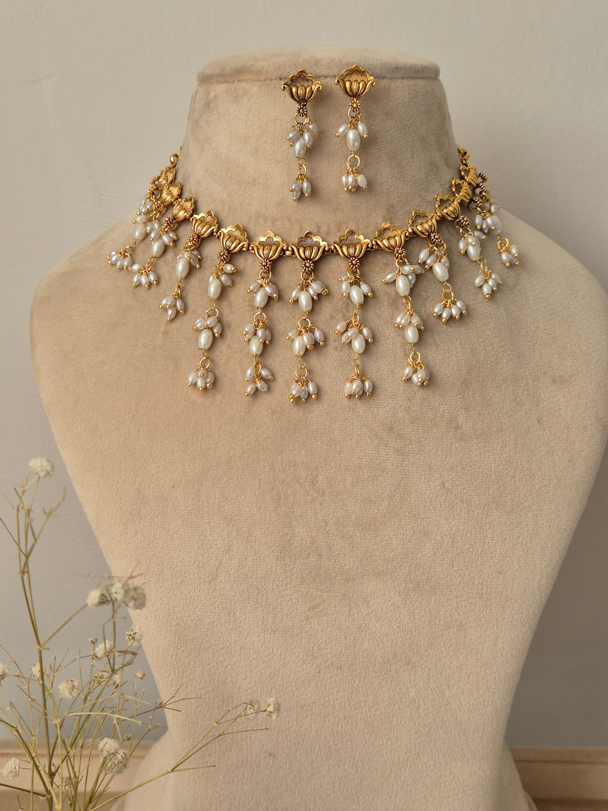 Gold and pearl necklace with same designed earrings, unique flowers shaped necklace by naitri.in
