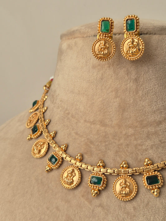 Gold jewelry set with emerald stones goddess motifs crafted antique craftmanship by naitri.in