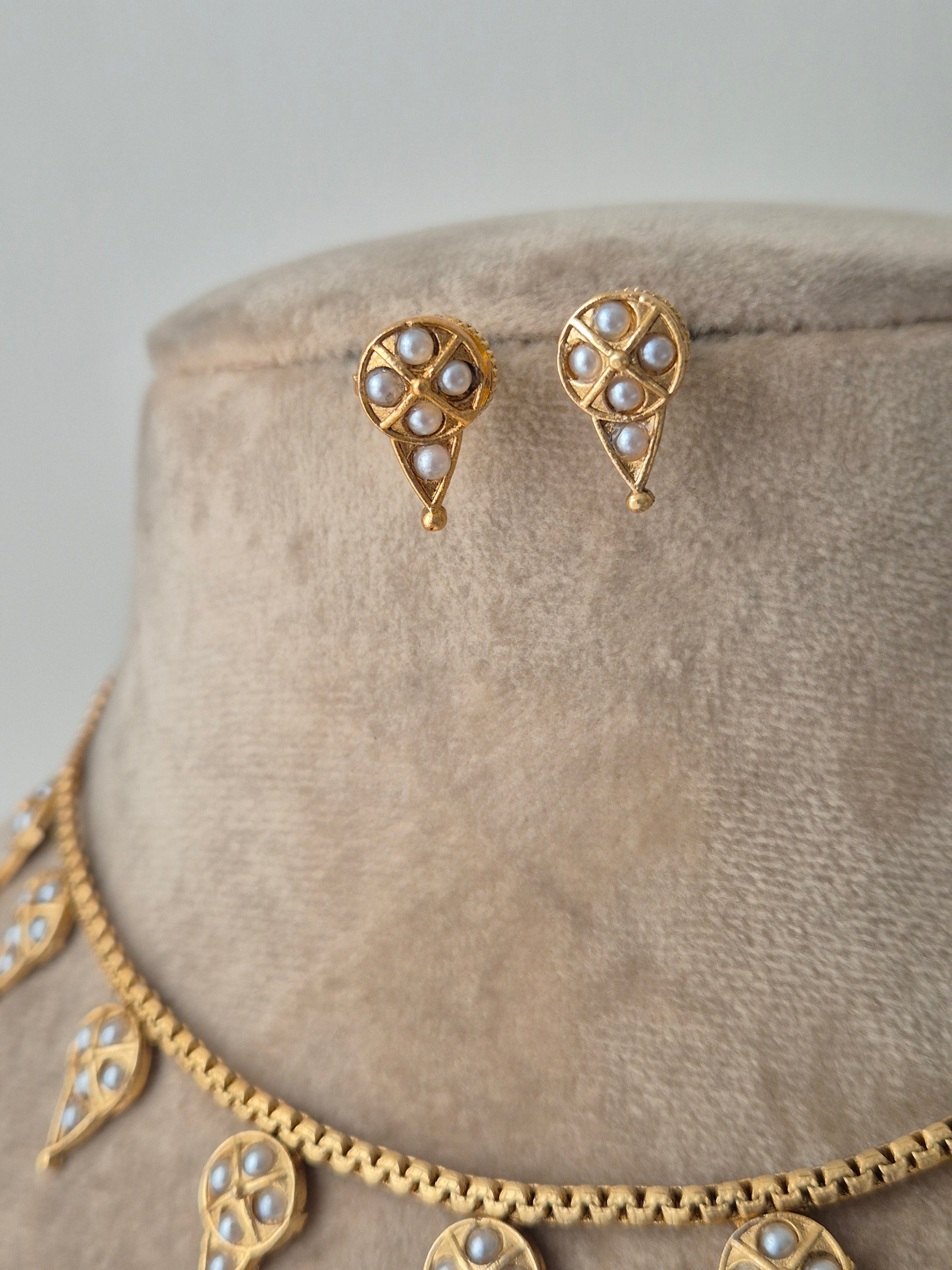 Cutely designed earring with golden drop shaped and small pearls attached on the earring fine and minimal by naitri.in