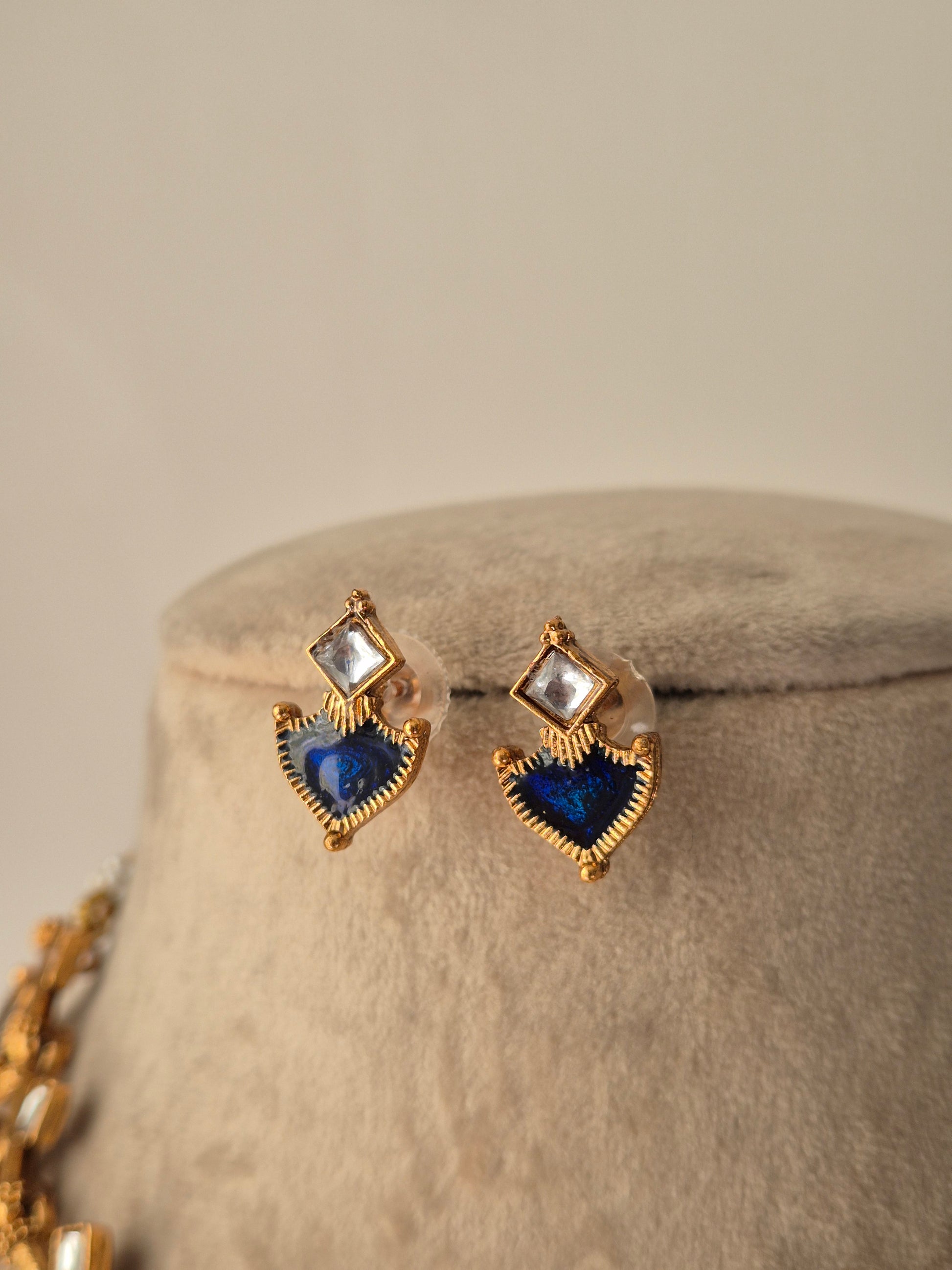 Heart-shaped earrings with blue and clear gemstones delicate Gold-plated Fiya earrings by naitri.in