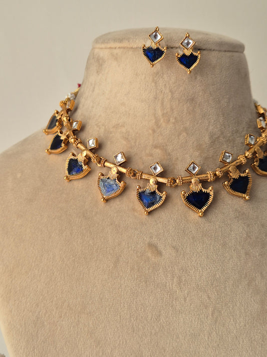 Gold necklace with blue and clear gemstones same designed earrings  Handmade imitation necklace set polished brass finish by naitri.in