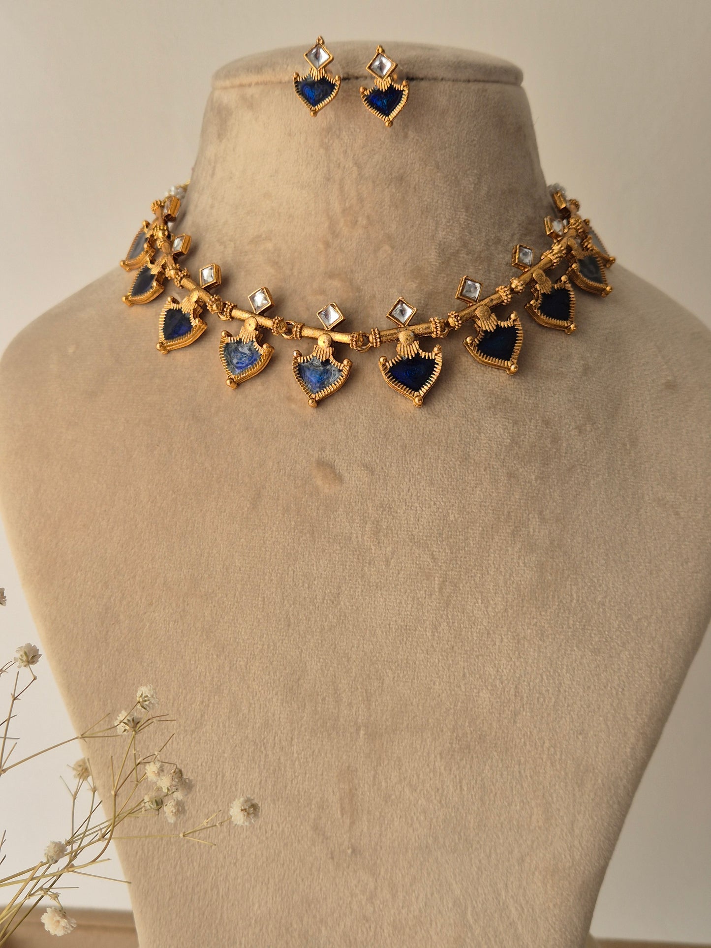 Decorative necklace with blue and gold elements and small square stones by naitri.in