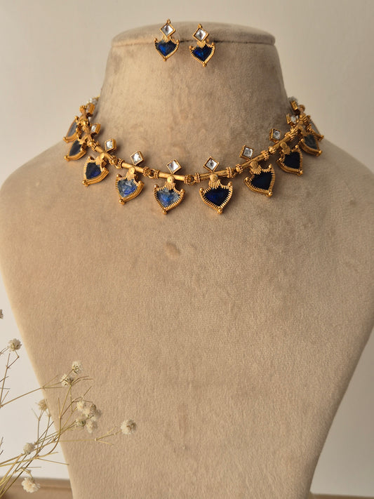 Decorative necklace with blue and gold elements and small square stones by naitri.in