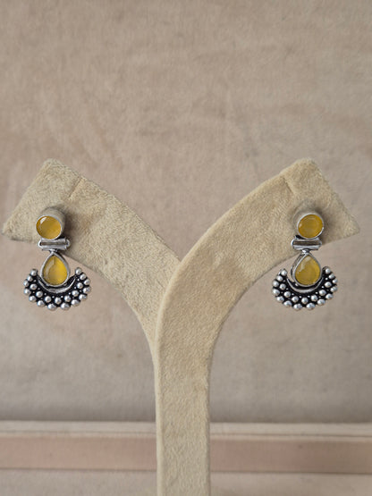 Modern Indian aesthetic silver-plated imitation jewelry drop earrings featuring a vibrant yellow focal stone  by naitri.in