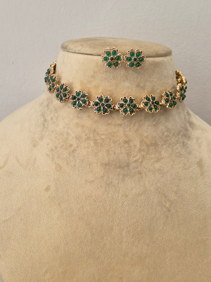 Elegant green stone and gold-toned ethnic choker necklace set, styled on a minimalist by naitri.in