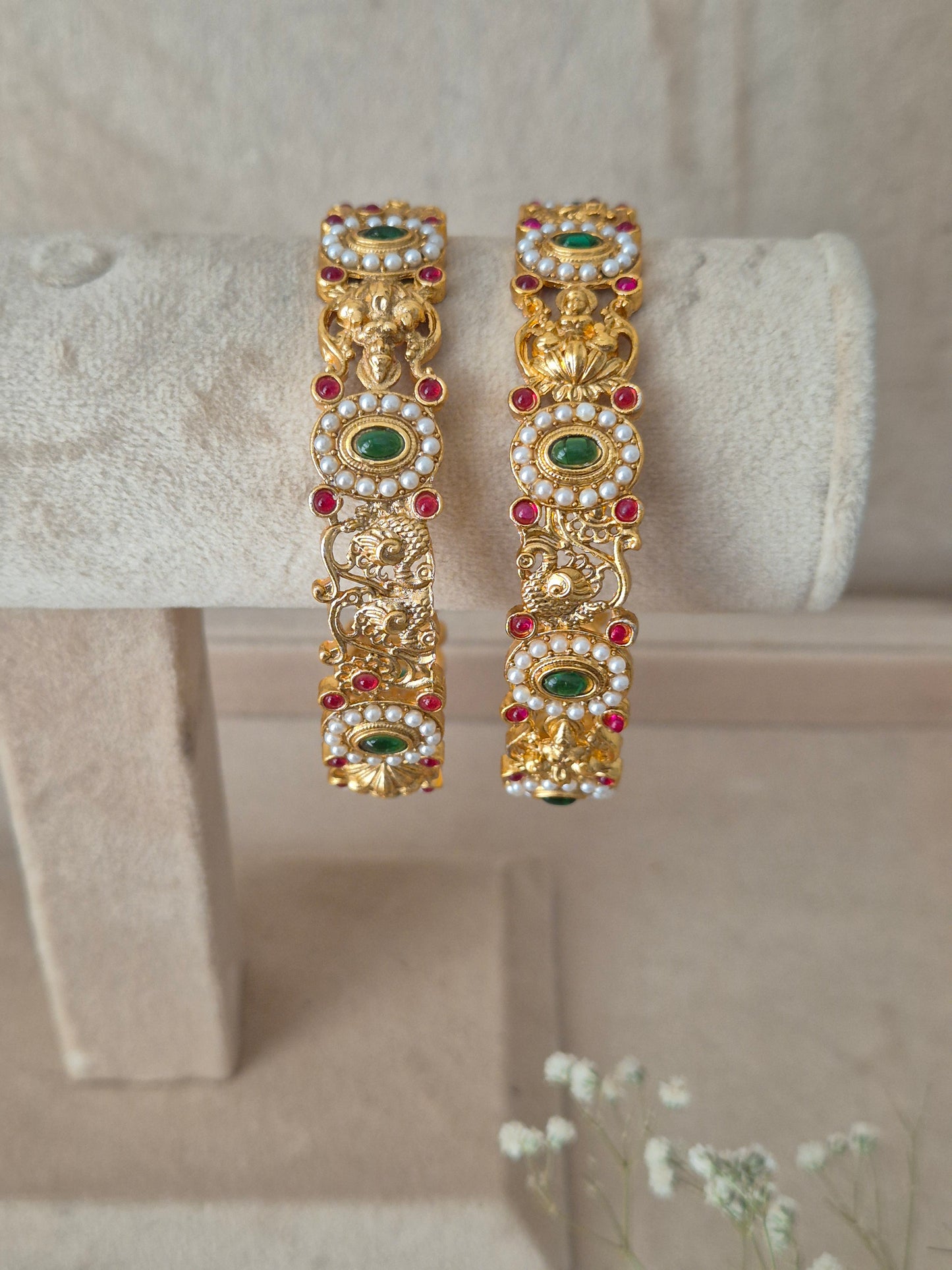 Elegant golden statement bangles with ethnic gemstone details by naitri.in