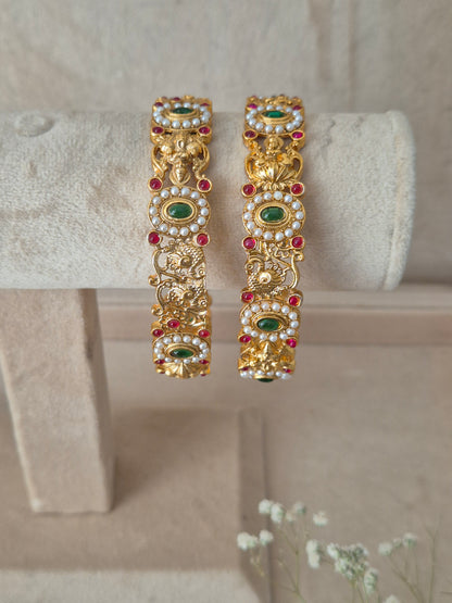 Elegant golden statement bangles with ethnic gemstone details by naitri.in