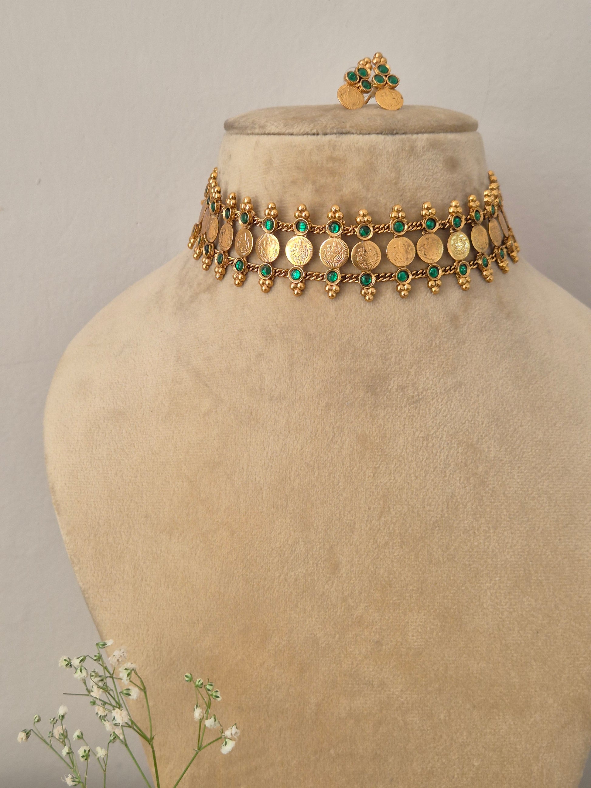 Elegant green gemstone and gold-toned ethnic coin jewelry set, Gold-plated traditional coin choker necklace with green bead drops and matching earrings by naitri.in