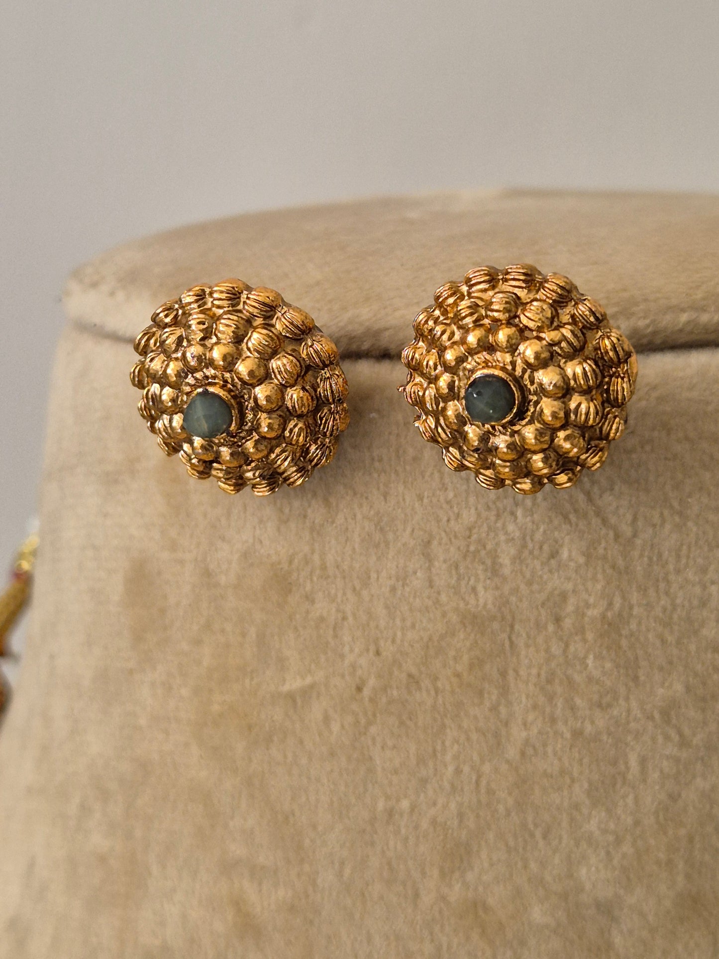 Traditional Gold-Plated Ethnic Stud Earrings with  floral-patterned grey stone in the middle by naitri.in