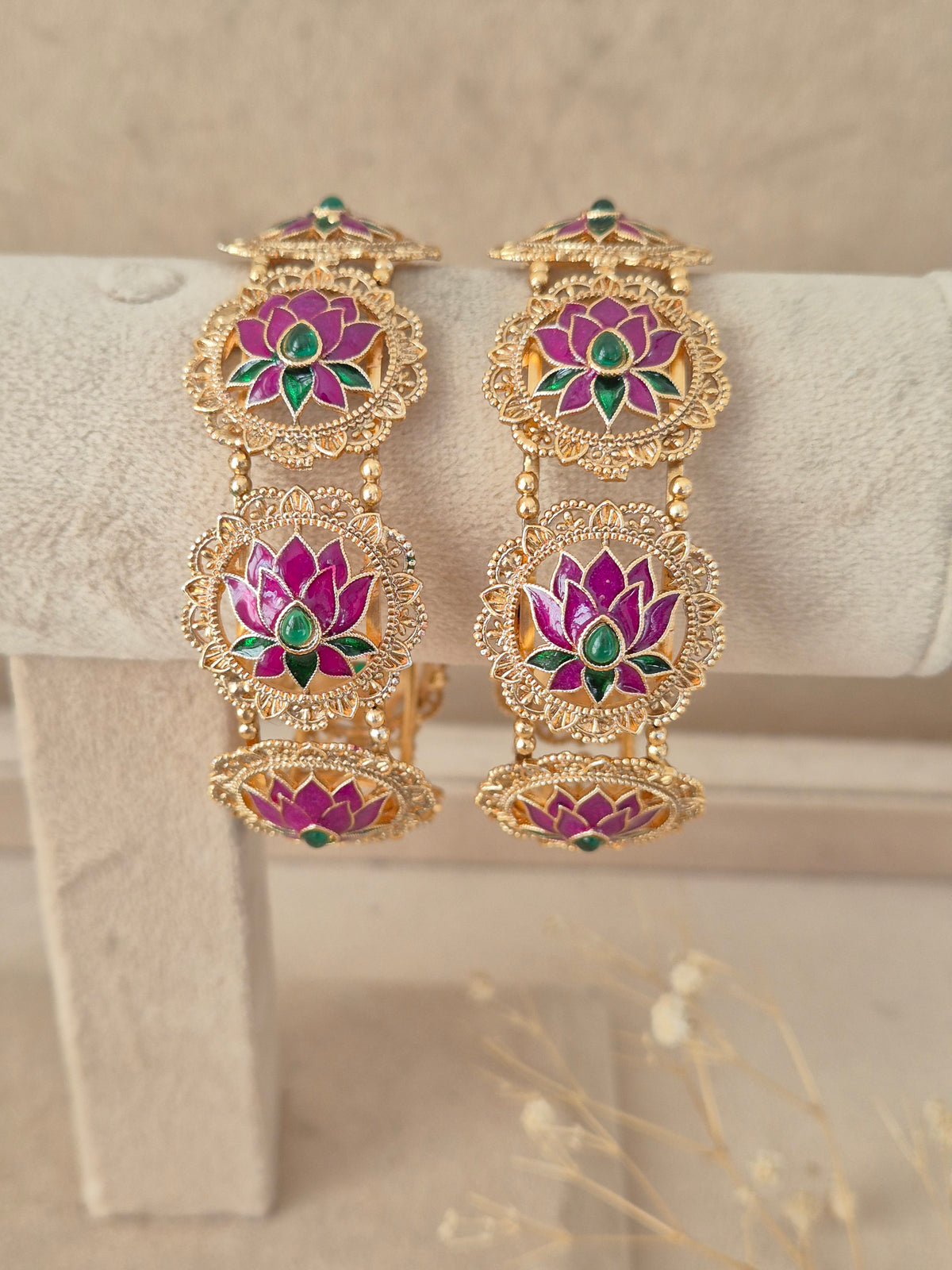 Set of two pink lotus motif gold-plated bangles by naitri.in