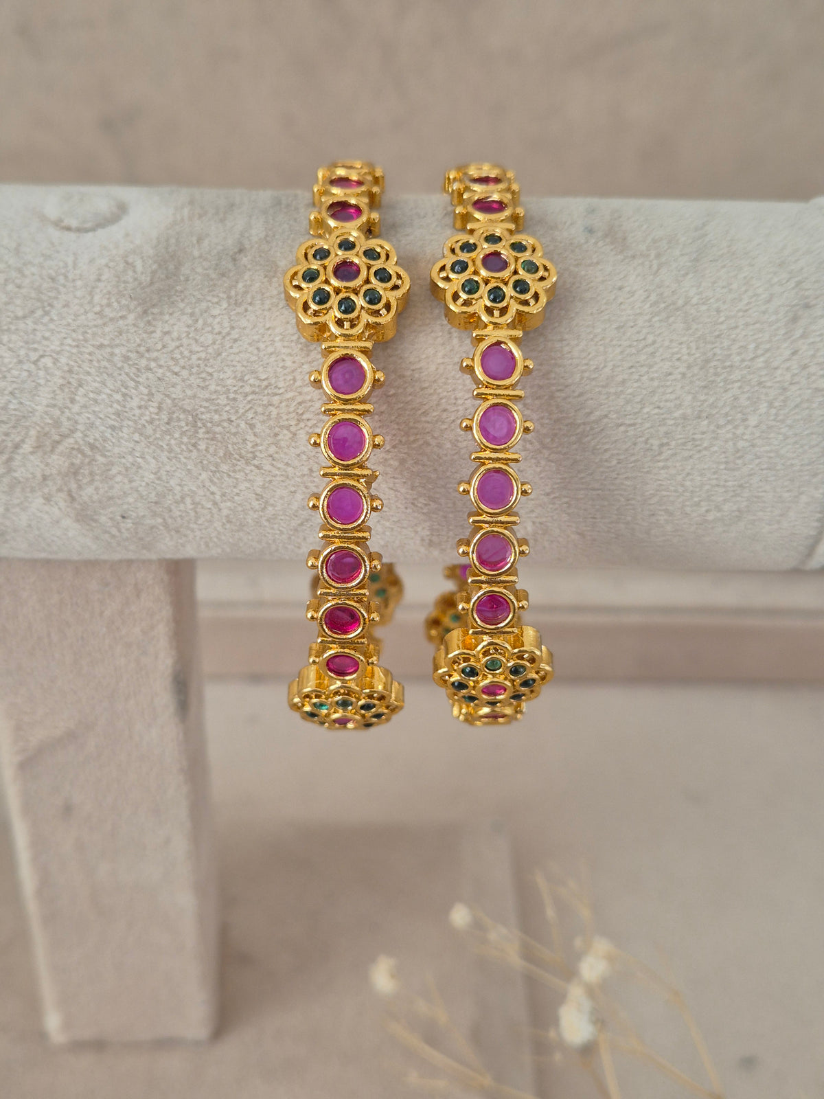 Set of two ruby and emerald stone-studded gold-plated bangles by naitri.in