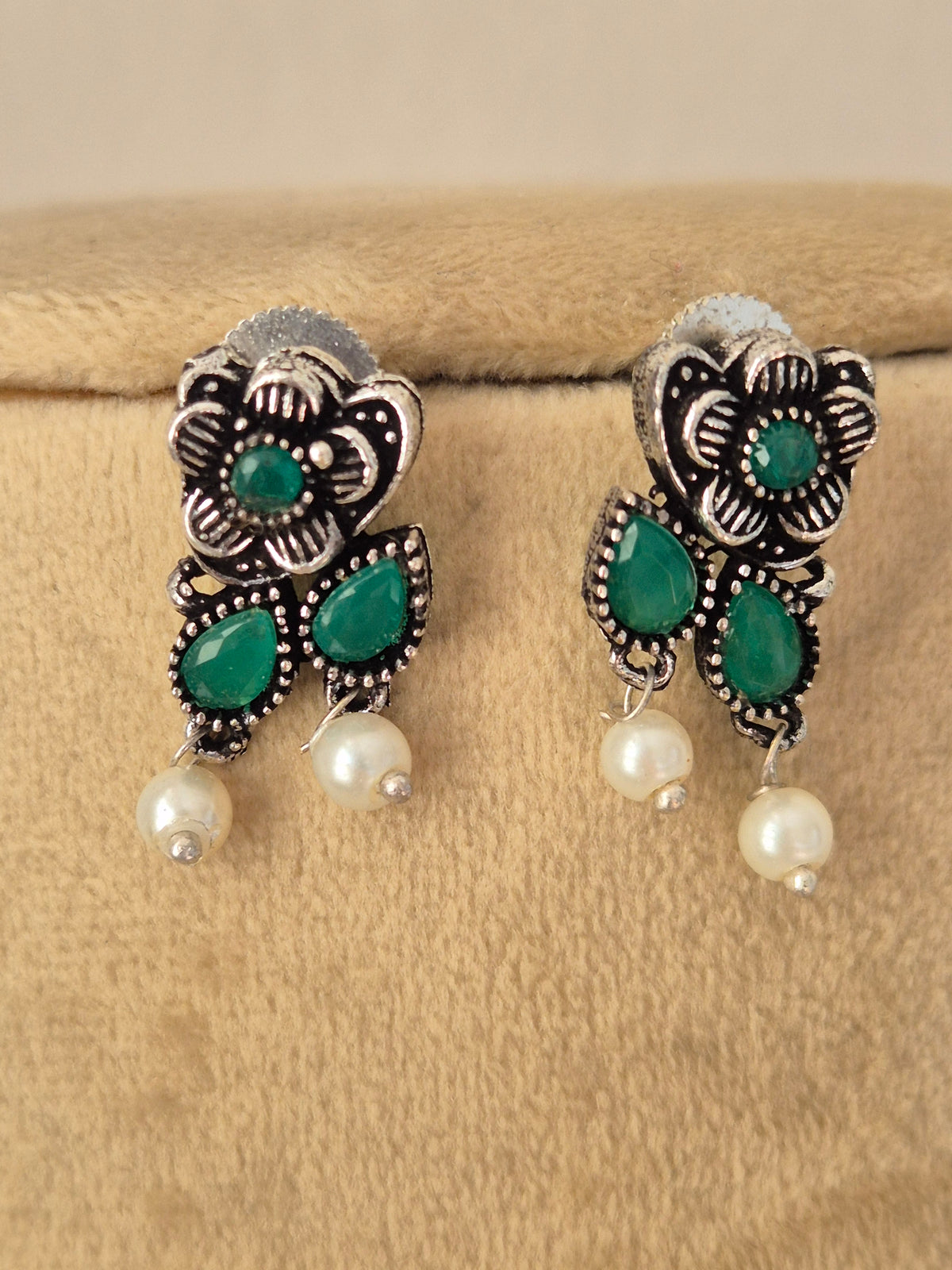 Pair of oxidized silver floral motif earrings green stone oxidized silver earrings  with dangling mini pearls by naitri.in