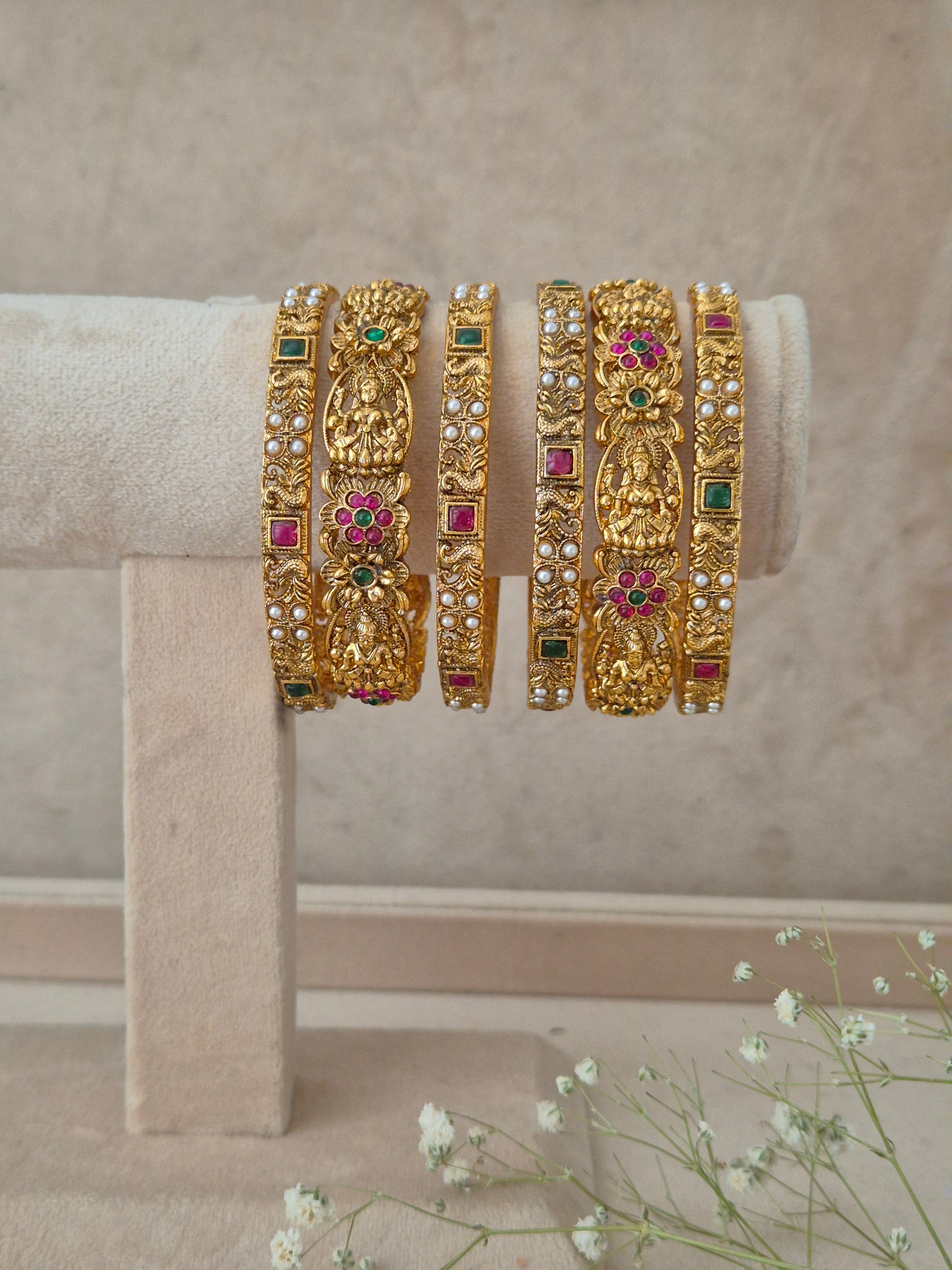  Antique gold-plated ethnic temple jewelry bangles with red and green stone detailing, Antique gold traditional Indian bangle set of 6 studded with red and green stones and temple motifs by naitri.in