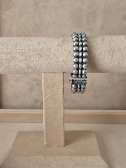 Antique silver oxidized Anchal bangle with an intricate textured design and fine geometric border engraving, by naitri.in