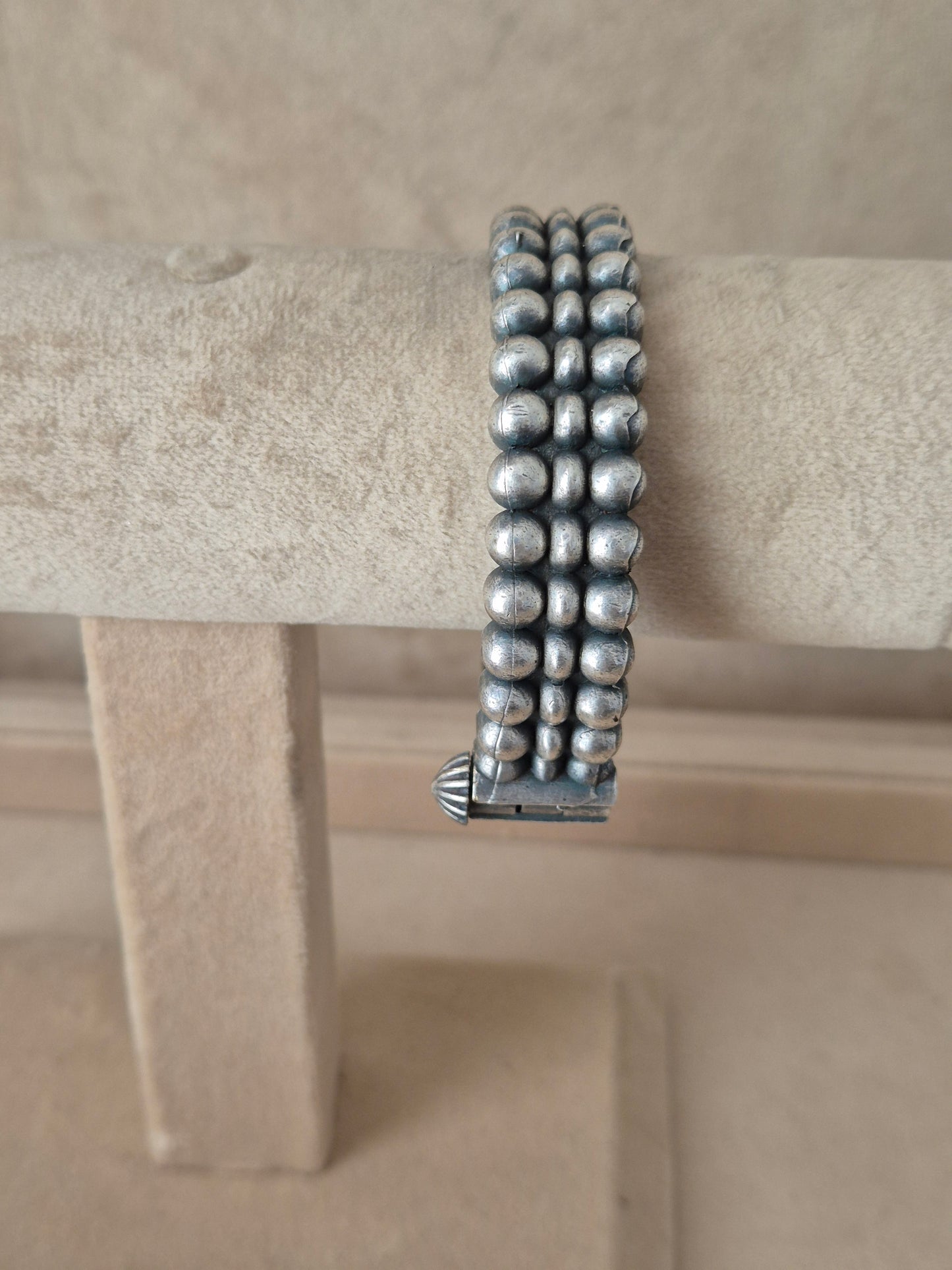 Detailed antique silver oxidized bangle with a textured geometric pattern by naitri.in