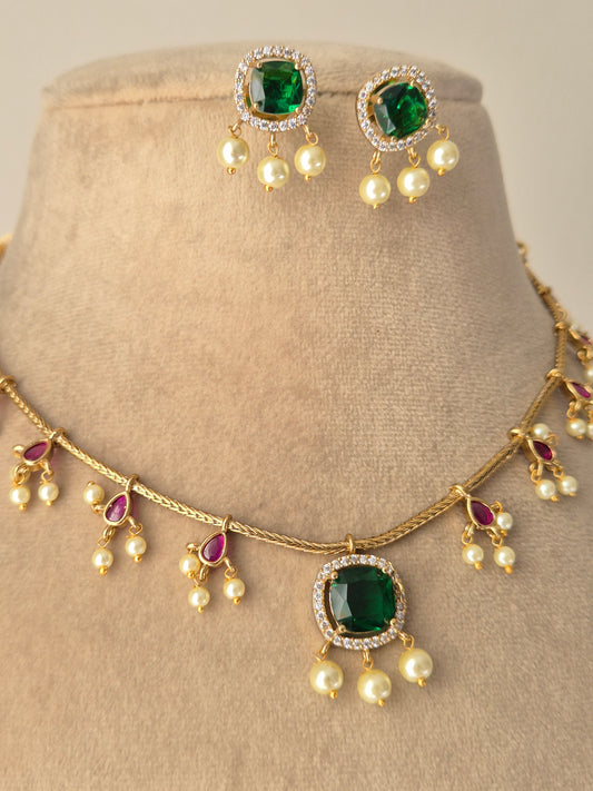 Gold-plated green gemstones and necklace set of Brass Alloy is actually quite good, but adding the pearl and red accent details makes it even better by naitri.in