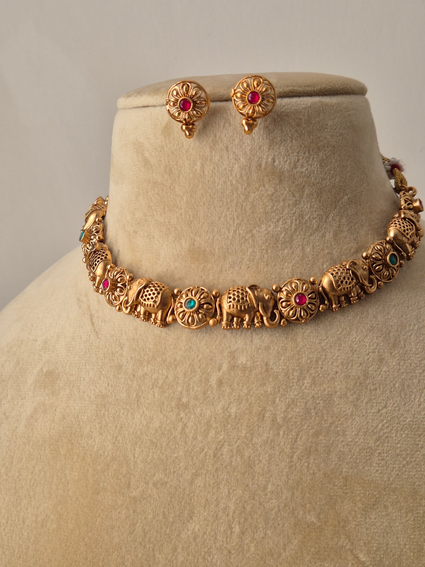 gold-toned necklace set with traditional elephant  carvings and multicolored stone embellishments by naitri.in