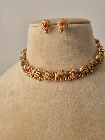 gold-toned necklace set with traditional elephant  carvings and multicolored stone embellishments by naitri.in