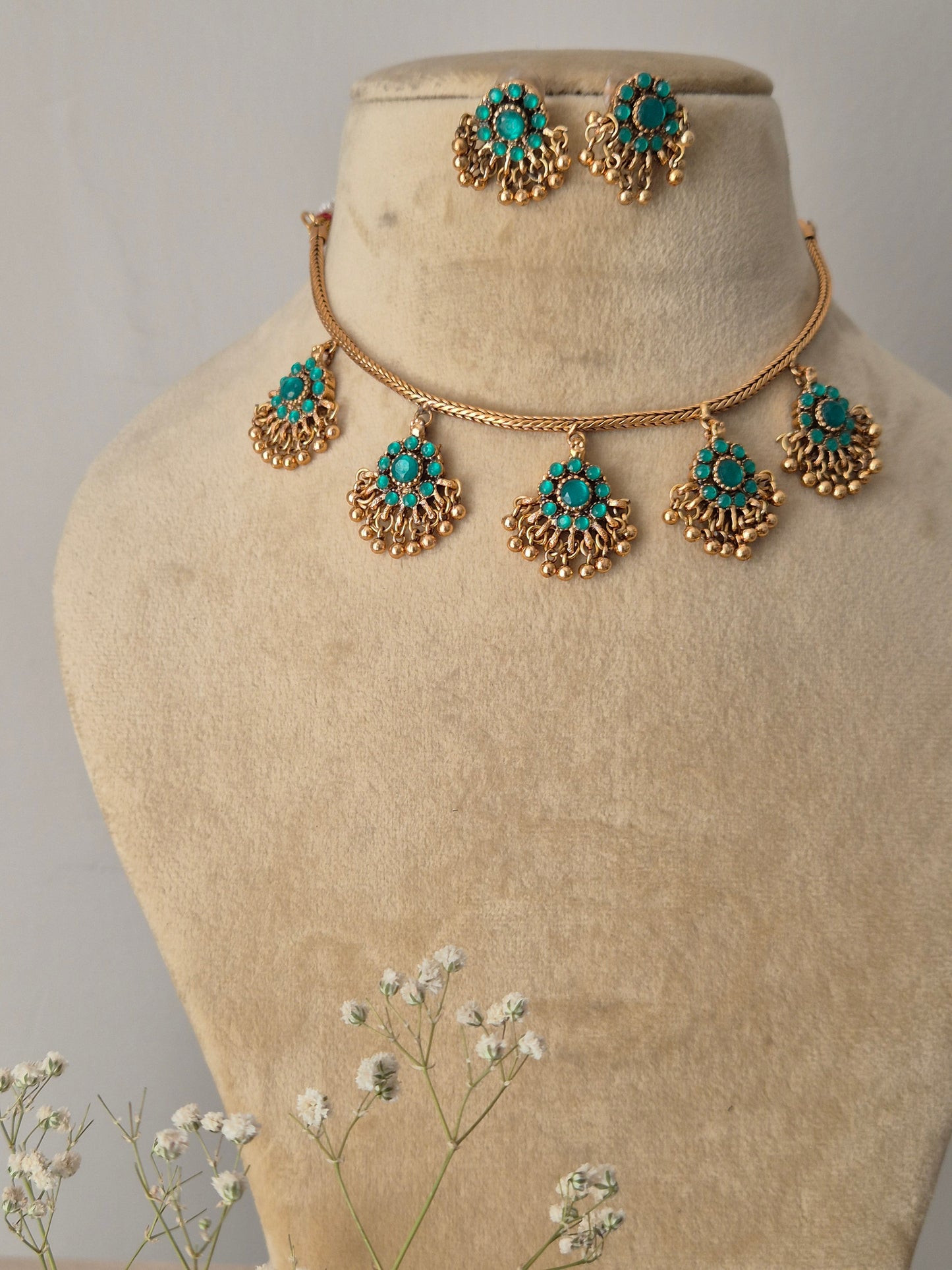 Handmade brass alloy necklace set with golden beadwork and turquoise-green stone accents, polished finish for ethnic and versatile occasional wear by naitri.in