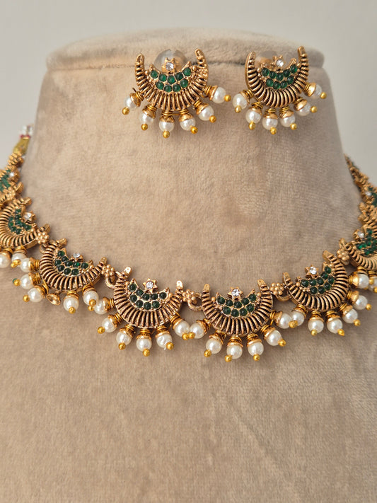 Detailed half moon and green stones in the middle with pearls attached outside eye-catching jewellery by naitri.in