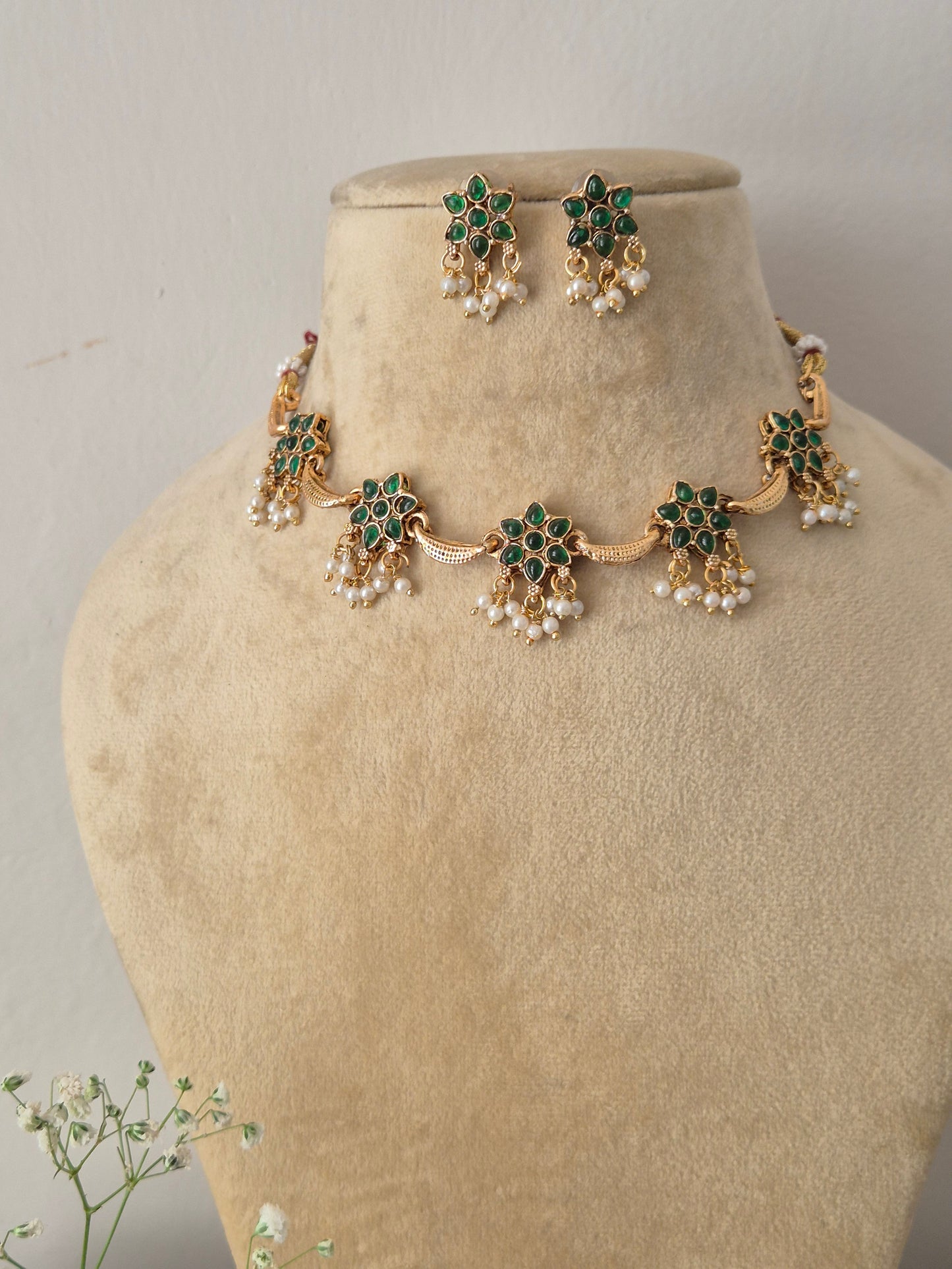 Elegant green gemstone and gold-toned ethnic choker jewelry set with delicate pearl hangings, by naitri.in