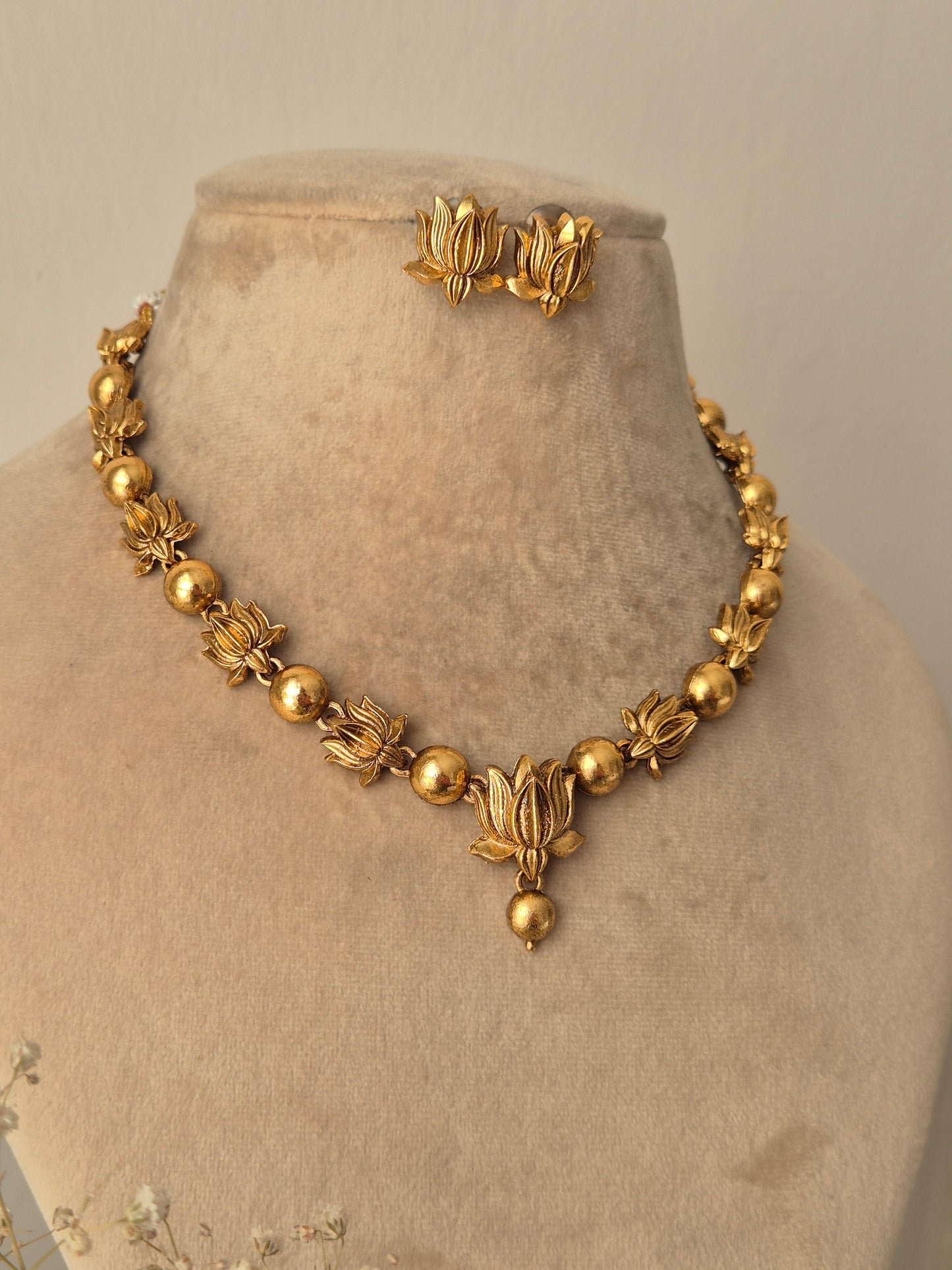 Harnoor Necklace Set - Golden floral brass jewelry with matching earrings. by naitri.in