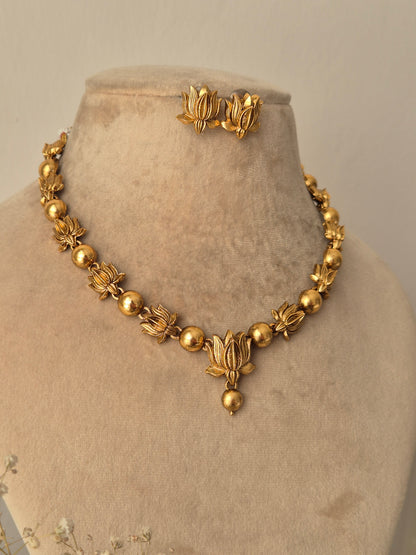 Harnoor Necklace Set - Golden floral brass jewelry with matching earrings. by naitri.in
