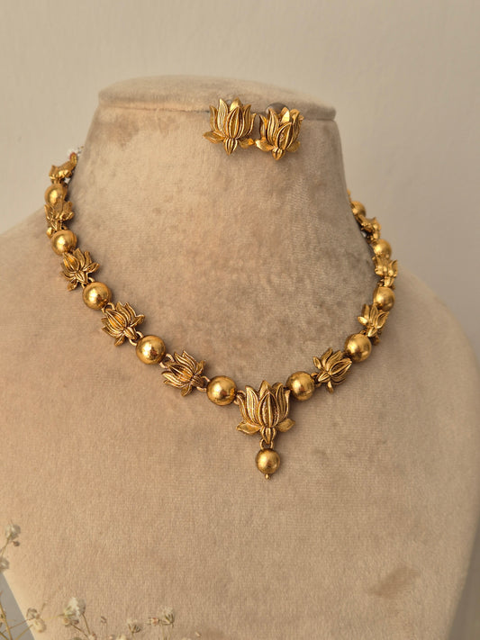 Harnoor Necklace Set - Golden floral brass jewelry with matching earrings. by naitri.in