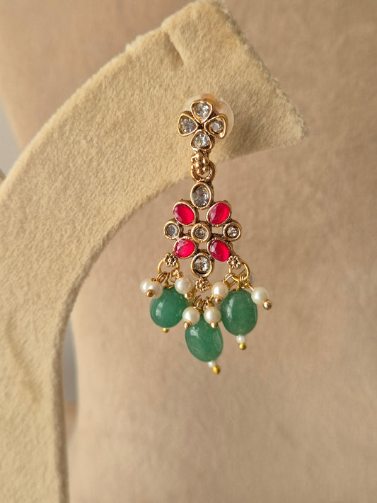 golden brass choker with pink stones, pearl detailing, and green bead droplets by naitri.in
