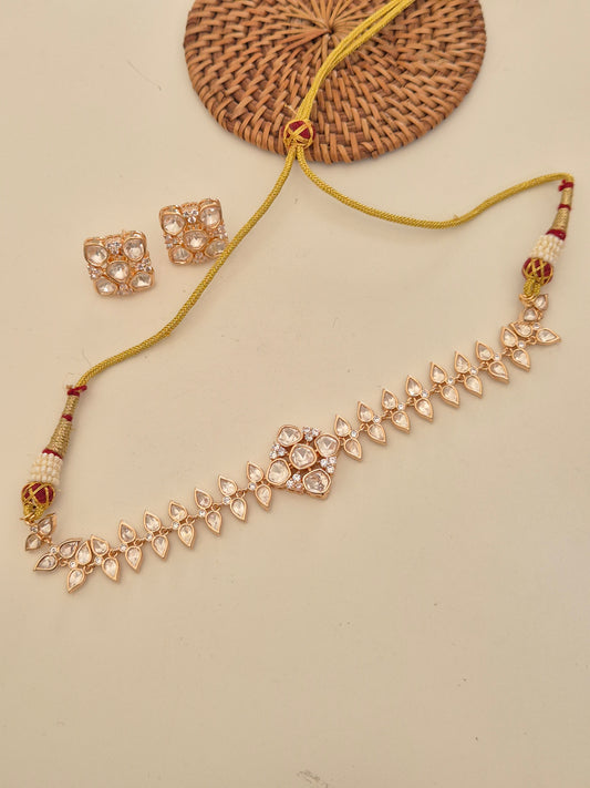The necklace set from Naitri, including a geometric choker-style American Diamond necklace and matching square stud earrings by naitri.in
