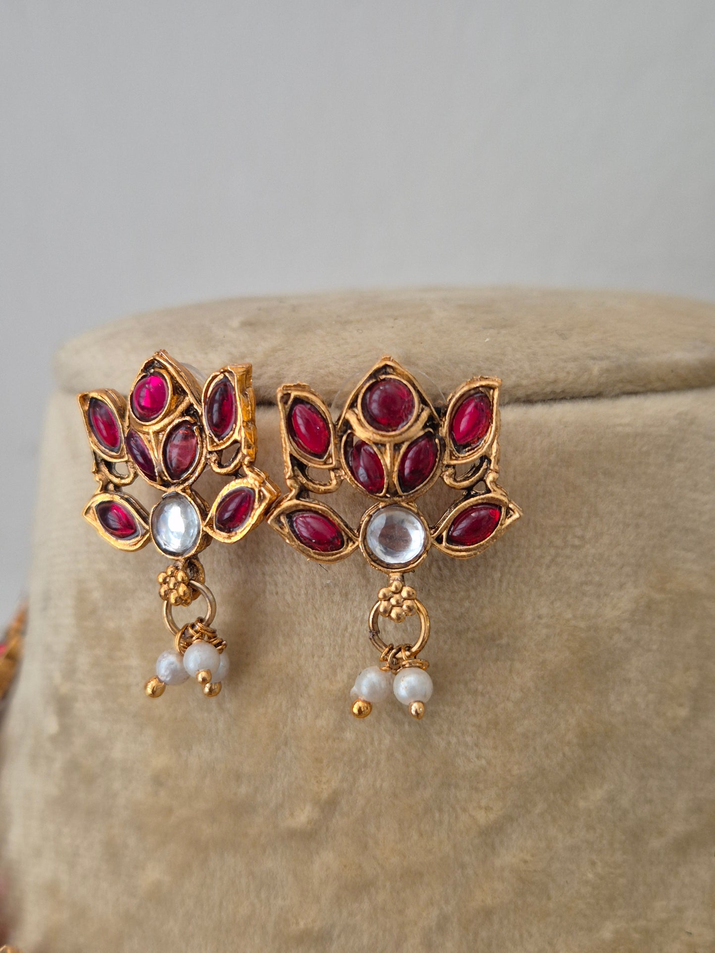 Traditional gold-plated earrings with red stones, dangling pearls, by naitri.in