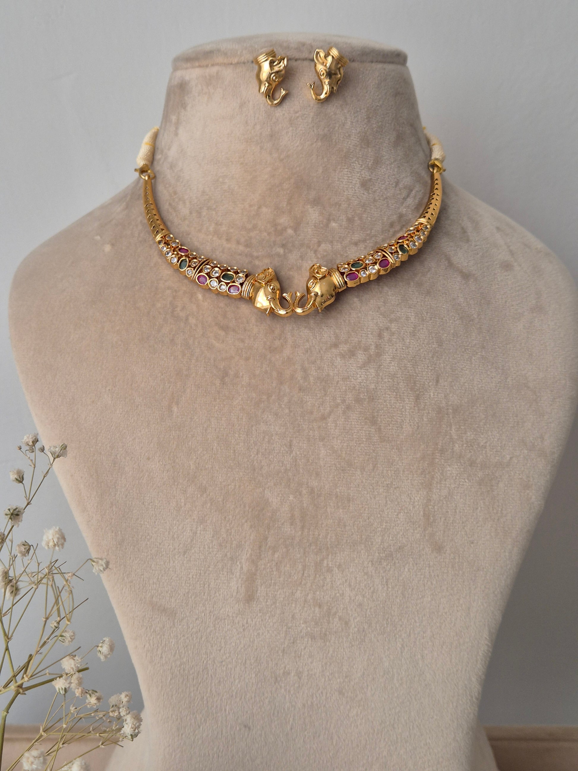 Gold necklace with colorful stones crafted elephants with elephant face studs by naitri.n