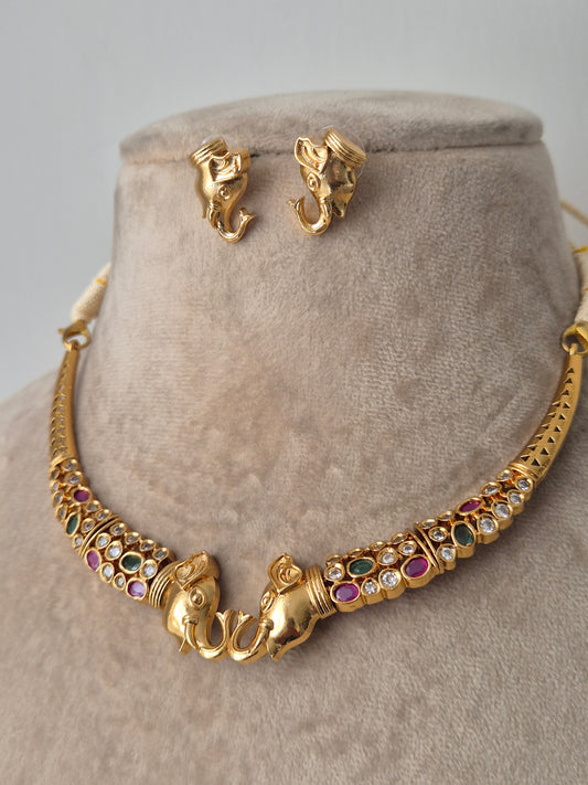Elephantastic golden necklace set with small studs with colourful stones by naitri.in