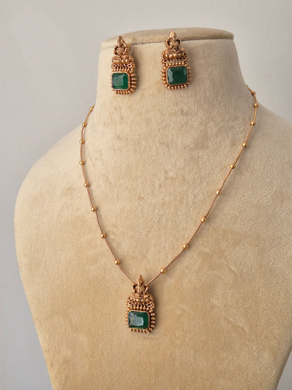 Hetal Necklace Set featuring a minimalist gold chain with a square green gemstone pendant and matching emerald-green stud earrings