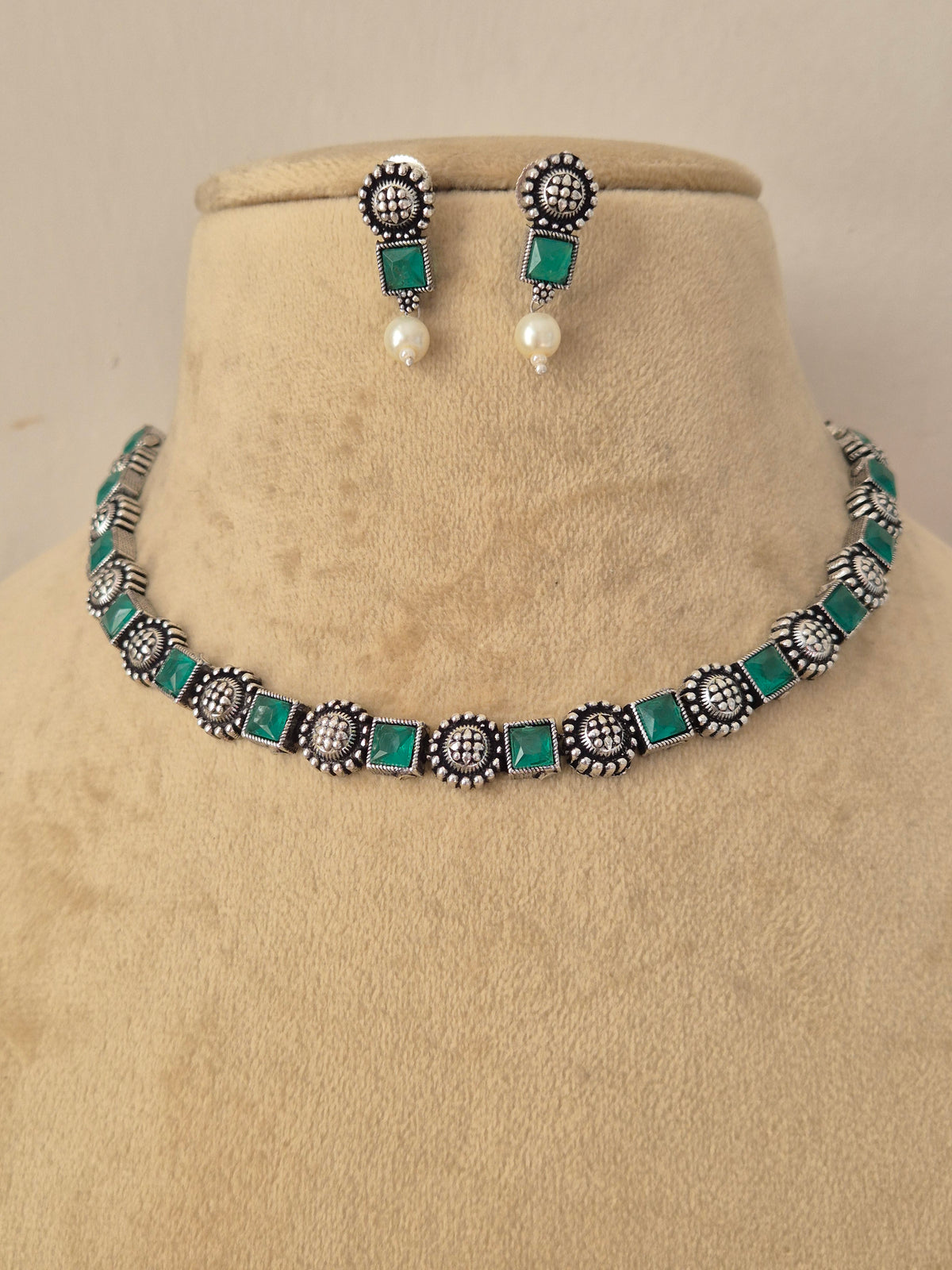 Hetashvi green stone oxidized silver necklace set with matching stud earrings , Handcrafted oxidized silver necklace and matching earrings with emerald green stones by naitri.in