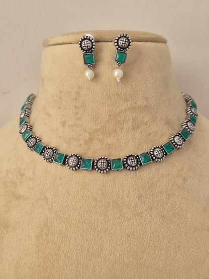 Hetashvi green stone oxidized silver necklace set with matching stud earrings , Handcrafted oxidized silver necklace and matching earrings with emerald green stones by naitri.in