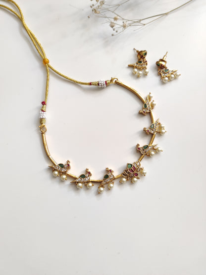 Classic gold-tone necklace set in metal alloy, photographed to highlight smooth finish and traditional look