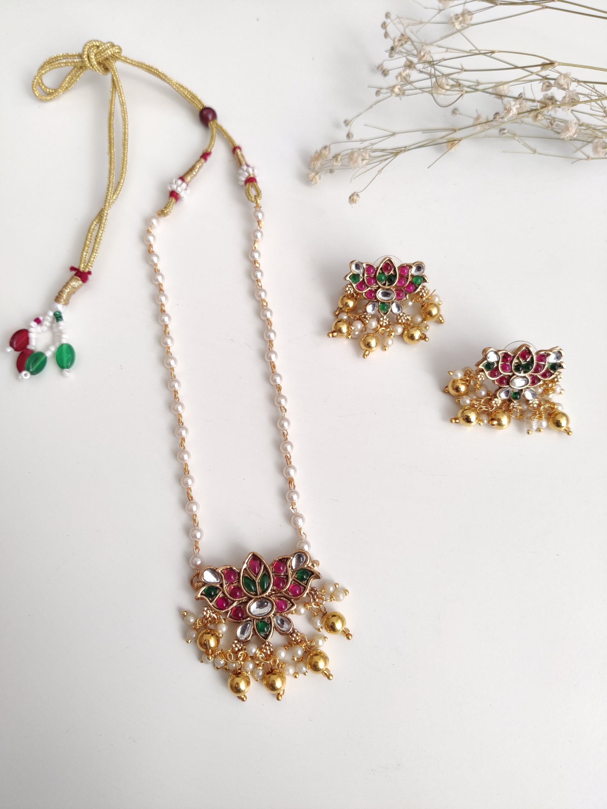 Temple necklace set with stud and dangle elements in gold-tone metal alloy, emphasizing detailed craftsmanship