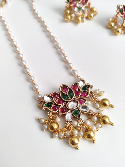Temple necklace set with stud and dangle elements in gold-tone metal alloy, emphasizing detailed craftsmanship