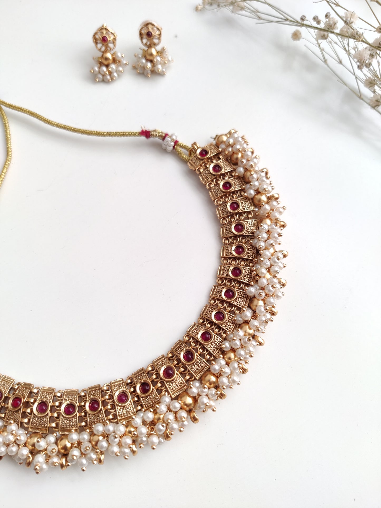Elegant gold-tone temple necklace set in metal alloy shown to highlight refined craftsmanship
