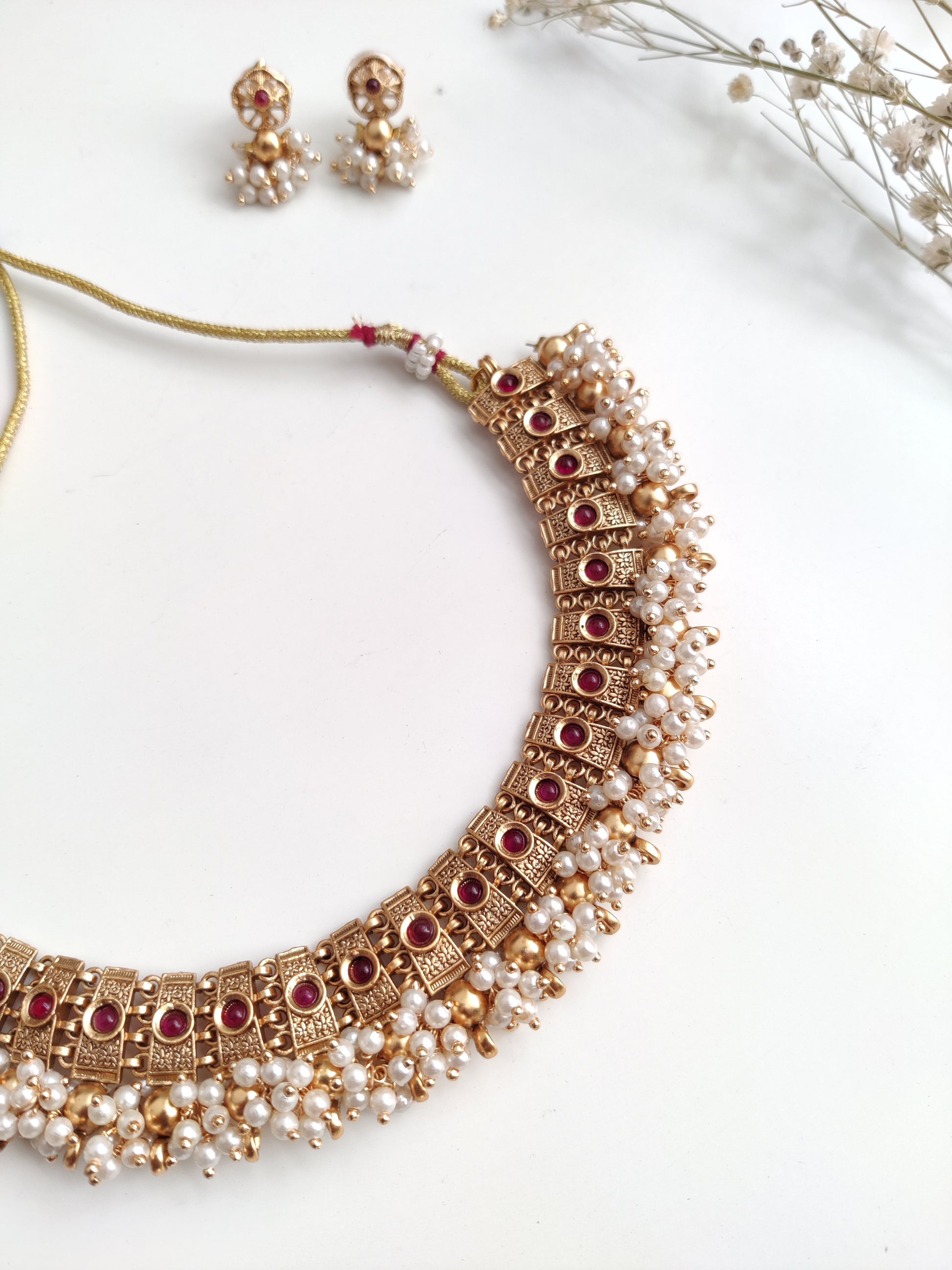 Elegant gold-tone temple necklace set in metal alloy shown to highlight refined craftsmanship