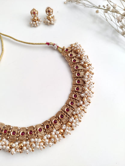 Elegant gold-tone temple necklace set in metal alloy shown to highlight refined craftsmanship